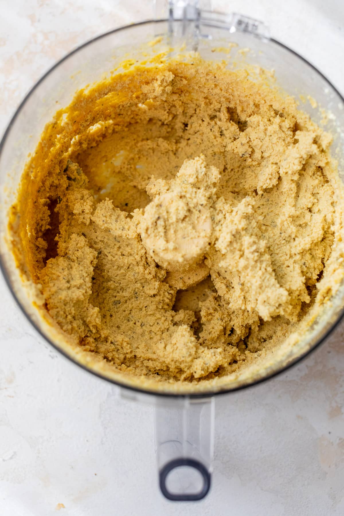 overhead view of a smooth vegan ricotta cheese for vegan lasagna in a food processor.