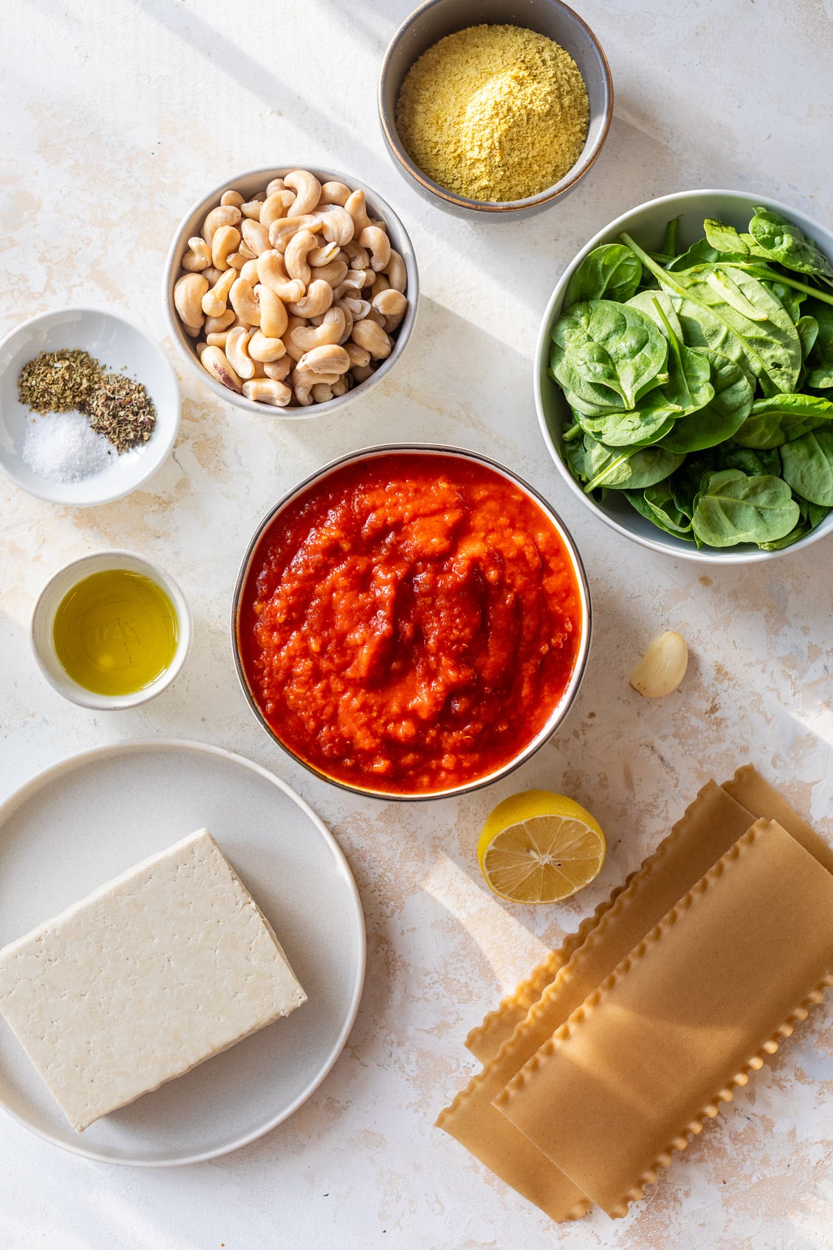 overhead view of the ingredients for vegan lasagna in individual bowls.