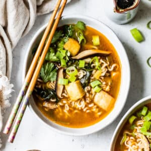 overhead view of a bowl of vegan ramen with chopsticks on top.