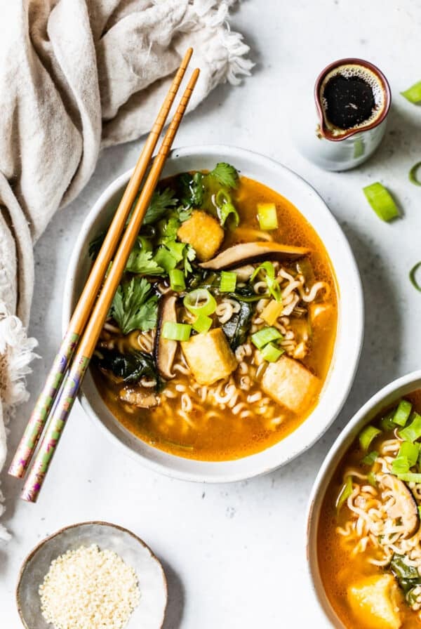 overhead view of a bowl of vegan ramen with chopsticks on top.