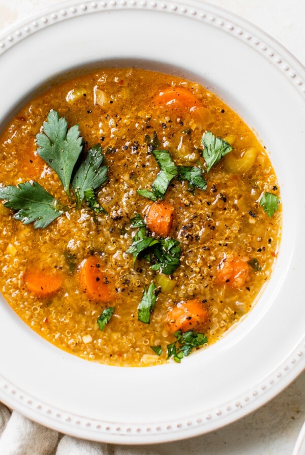 a bowl of vegetable soup with quinoa