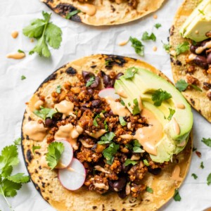 close up of a taco on parchment paper with cilantro
