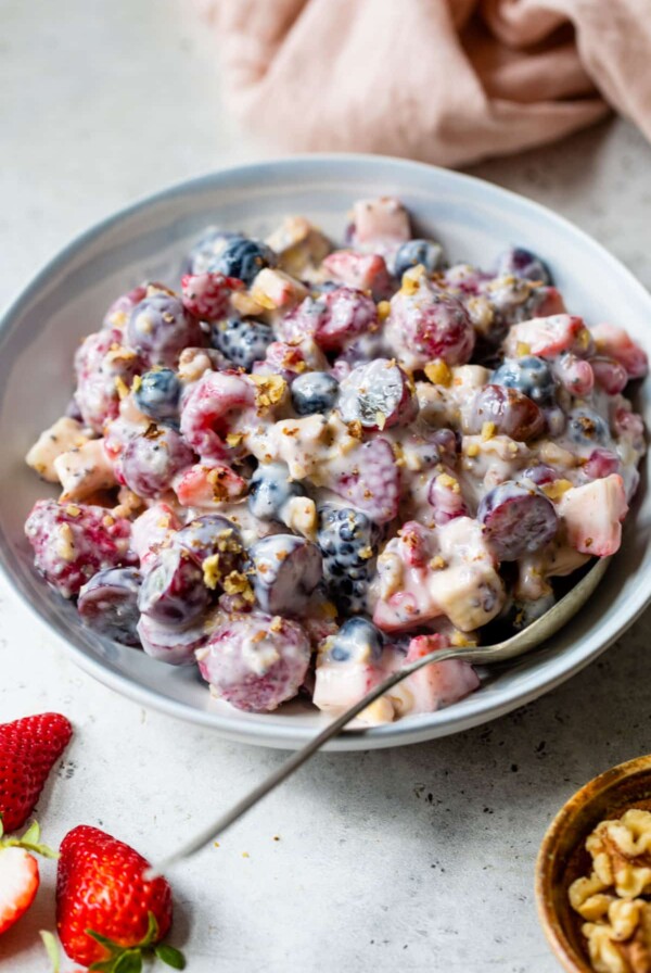 greek yogurt fruit salad in a bowl with a spoon